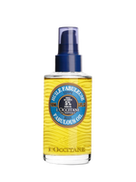 L'Occitane body oil spray bottle on a white background