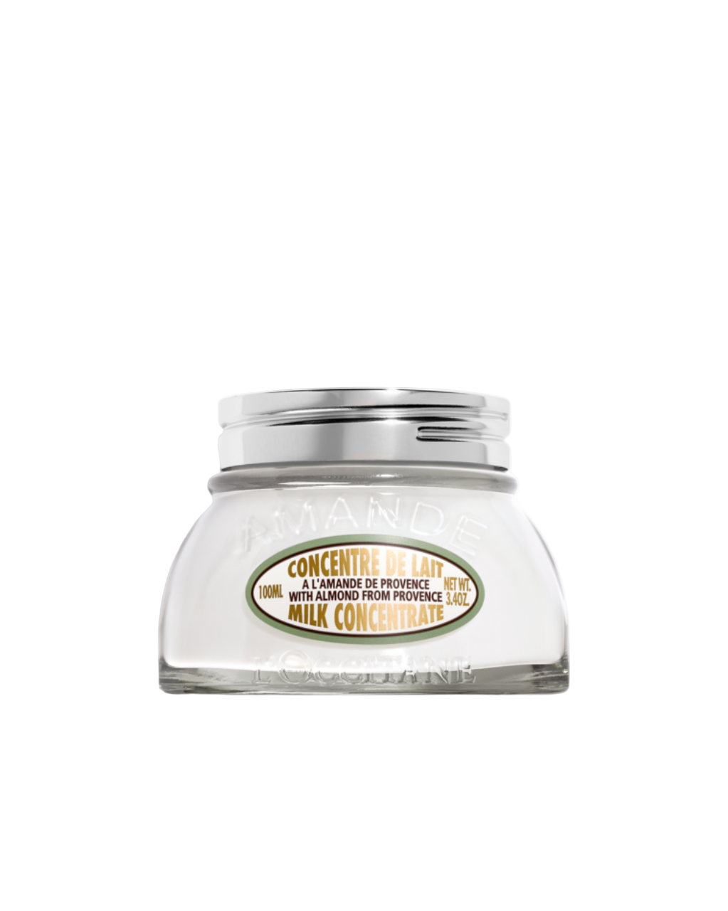 Glass jar of milk concentrate with a silver lid on a white background